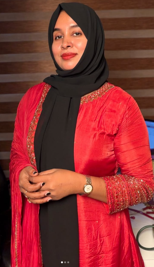 The founder and brand model of Dr Asla’s Asli Herbals, wearing a red outfit and black headscarf